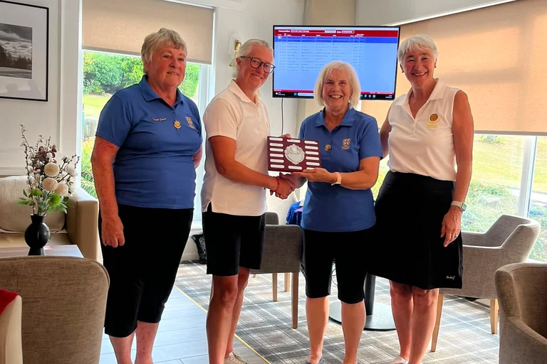 Helen receives the Dunn/Mair trophy for the winning team, pictured with NLCGA President Viv Younger, Anne Mair, Durham President and Marian Goodyear, Durham Captain