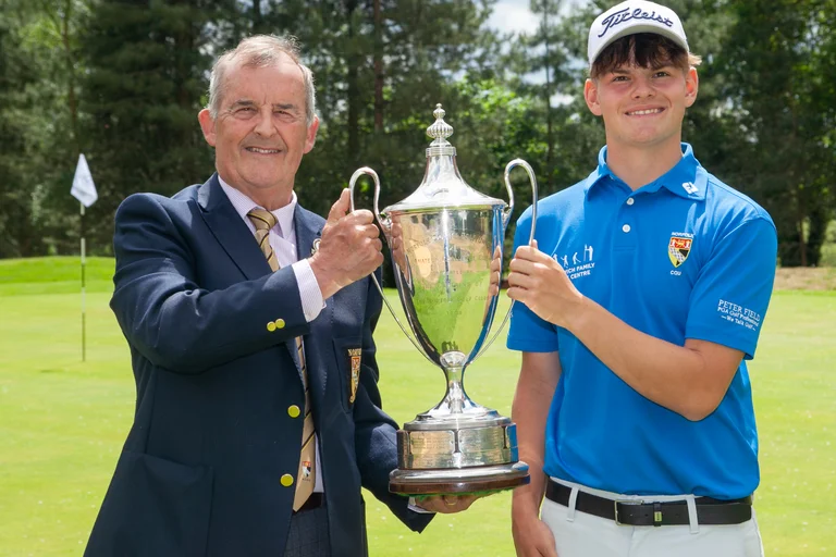 Norfolk County Golf Union president Stuart Goodman hands over the silverware to Norfolk Amateur champion Sully Goddard